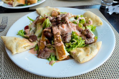 Meat caesar - beef salad with toasted bread, cherry tomatoes and cheese sauce