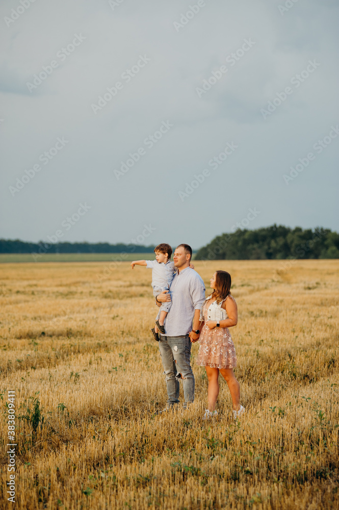 Happy family in the field evening light of a sun. Happy family in the field evening light of a sun.