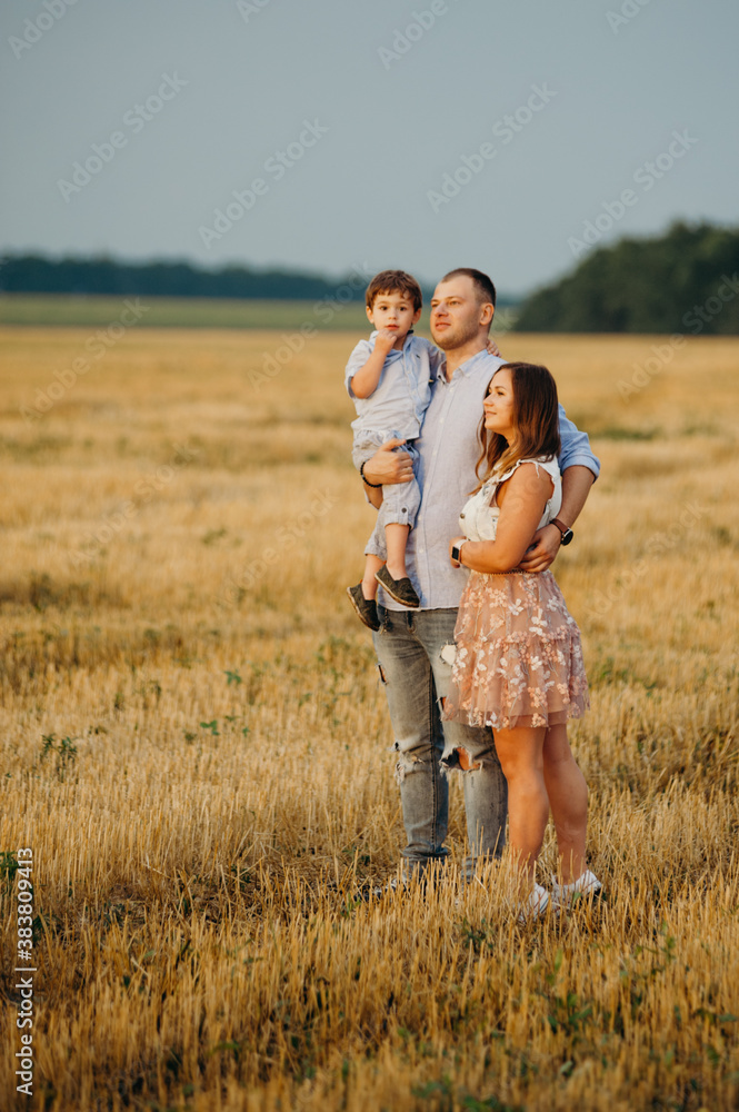 Happy family in the field evening light of a sun. Happy family in the field evening light of a sun.
