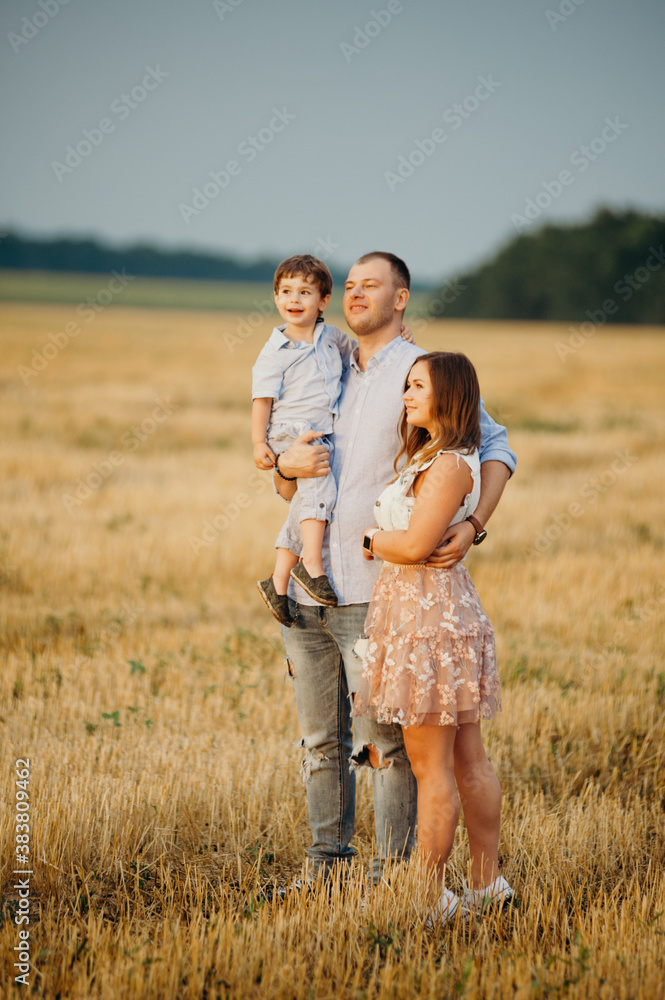 Happy family in the field evening light of a sun. Happy family in the field evening light of a sun.