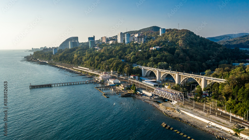 Drone view of pier of Matsesta marine station an the background of the viaduct in summer day in sunset, Sochi, Russia. Aerial view