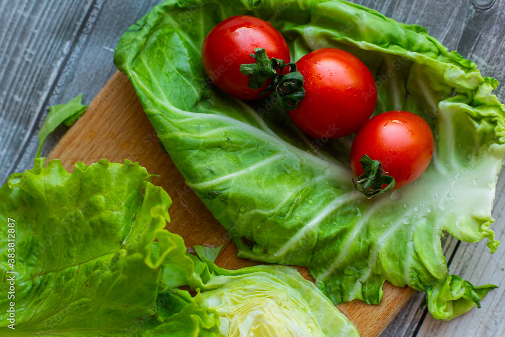 cherry tomatoes with cabbage and salad on a cutting board cherry tomatoes with cabbage and salad on a cutting board
