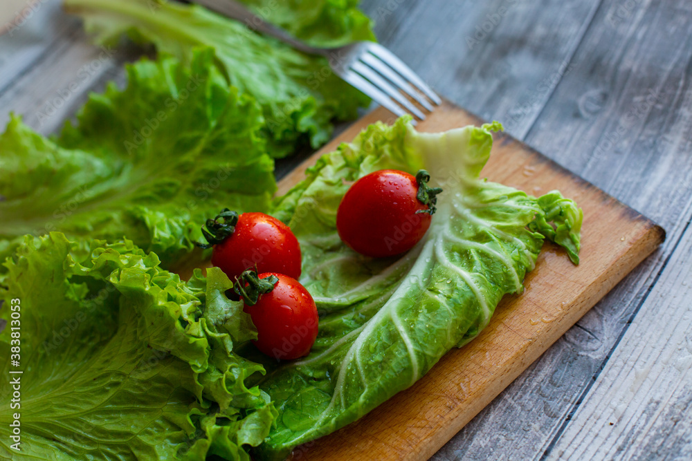 cherry tomatoes with cabbage and salad on a cutting board cherry tomatoes with cabbage and salad on a cutting board