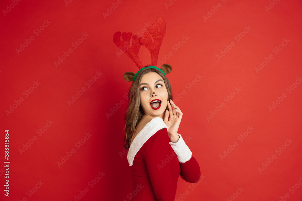 Cute posing. Greetingcard. Concept of Christmas, 2021 New Year's, winter mood, holidays. Copyspace for ad, postcard. Beautiful caucasian woman with long hair like Santa's Reindeer catching giftbox. Cute posing. Greetingcard. Concept of Christmas, 2021 New Year's, winter mood, holidays. Copyspace for ad, postcard. Beautiful caucasian woman with long hair like Santa's Reindeer catching giftbox.