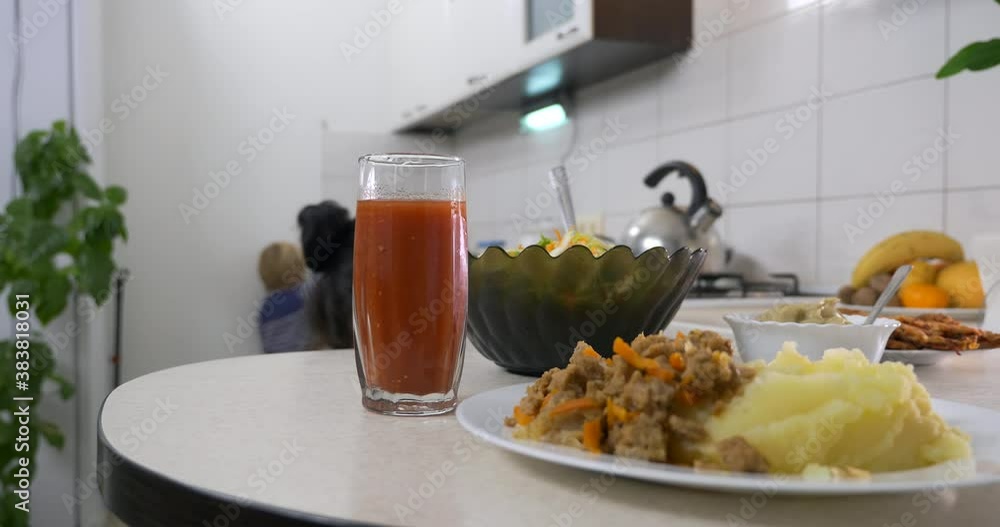 Close-up Potato Puree with Soy Meat Salad Tomato Juice on Serving Dishes. Vegetarian Vegan Food Meal on Kitchen Table at Home 4K Close-up Potato Puree with Soy Meat Salad Tomato Juice on Serving Dishes. Vegetarian Vegan Food Meal on Kitchen Table at Home 4K