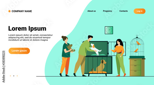 Pet store or animal shelter concept. Man taking puppy from cage, buying or adopting dog. Volunteers helping to choose homeless animal for adoption