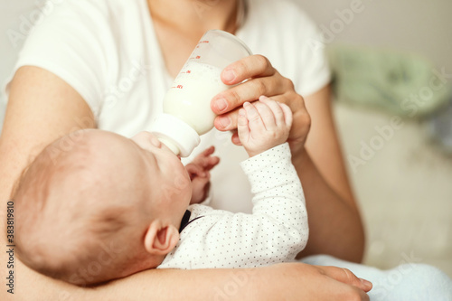 baby eats milk from a bottle
