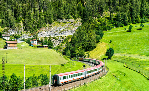 Passenger train at the Brenner Railway in the Austrian Alps photo