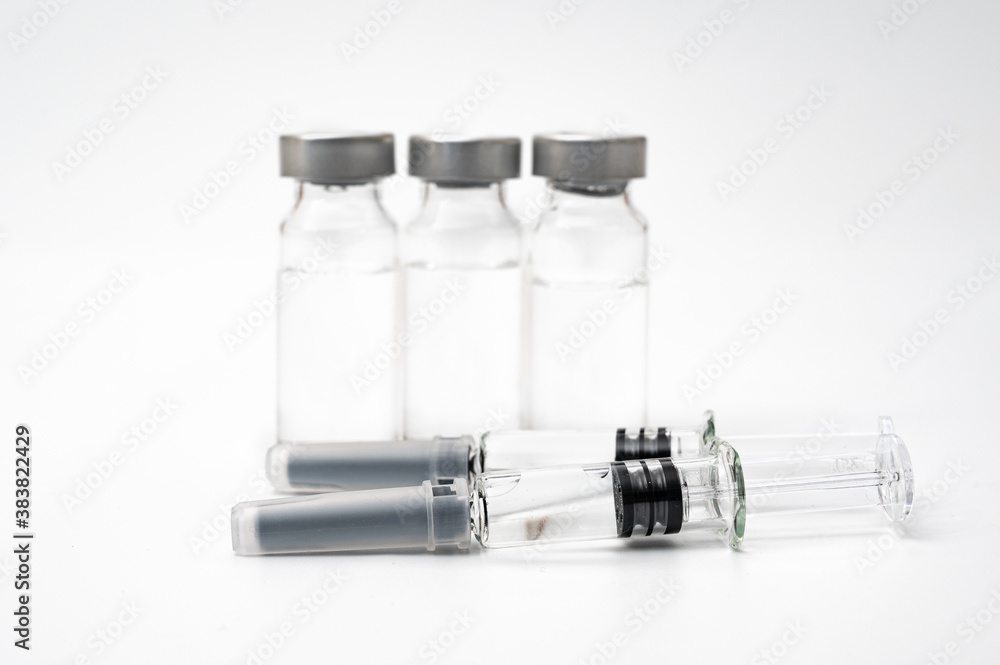 Vaccine concept with syringe and vial on a white background. Vaccine concept with syringe and vial on a white background.