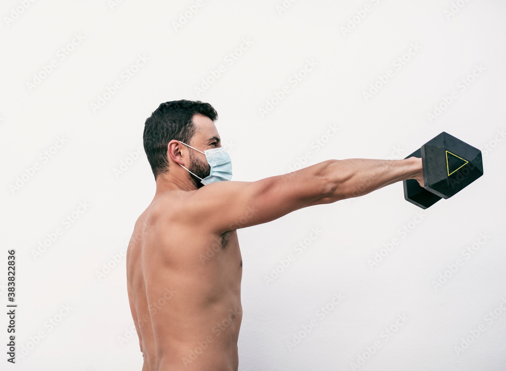 Fototapeta premium Covid-19 sport trainer lifting weights