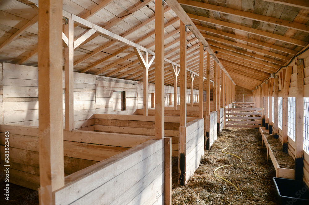 Empty woden stable/ barn with hay on the floor Empty woden stable/ barn with hay on the floor
