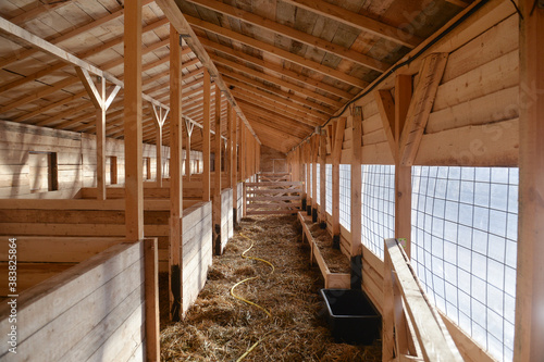 Empty woden stable/ barn with hay  on the floor