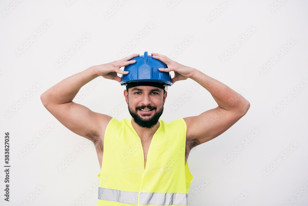 Stressed construction worker posing with raised arms happy d Stressed construction worker posing with raised arms happy d
