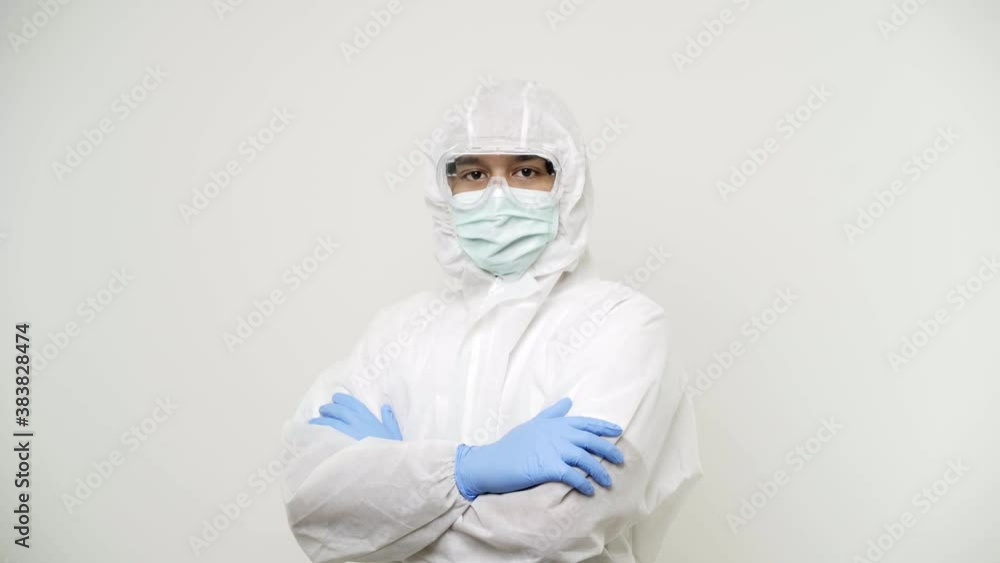 Asian Doctors or healthcare worker standing on white isolate background put on a uniform wearing a blue hand grove for protection and cross his arm in the clinic or hospital. 4K Resolution. Asian Doctors or healthcare worker standing on white isolate background put on a uniform wearing a blue hand grove for protection and cross his arm in the clinic or hospital. 4K Resolution.