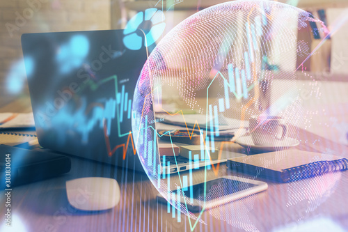 Double exposure of graph and financial info and work space with computer background. Concept of international online trading.