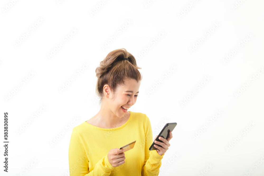Young woman using phone and credit card to shopping online Young woman using phone and credit card to shopping online