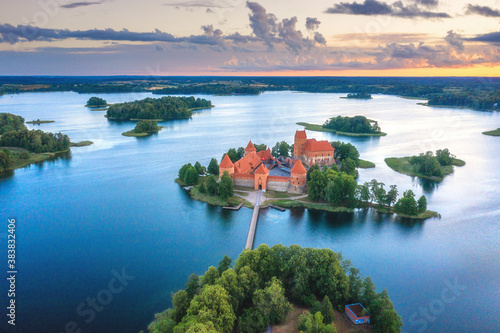 Summer landscape. Aerial view of Trakai castle. Historical sightseeings of Lithuania. Early sunrise. Green islands among of lake. Blue water in lake.  photo