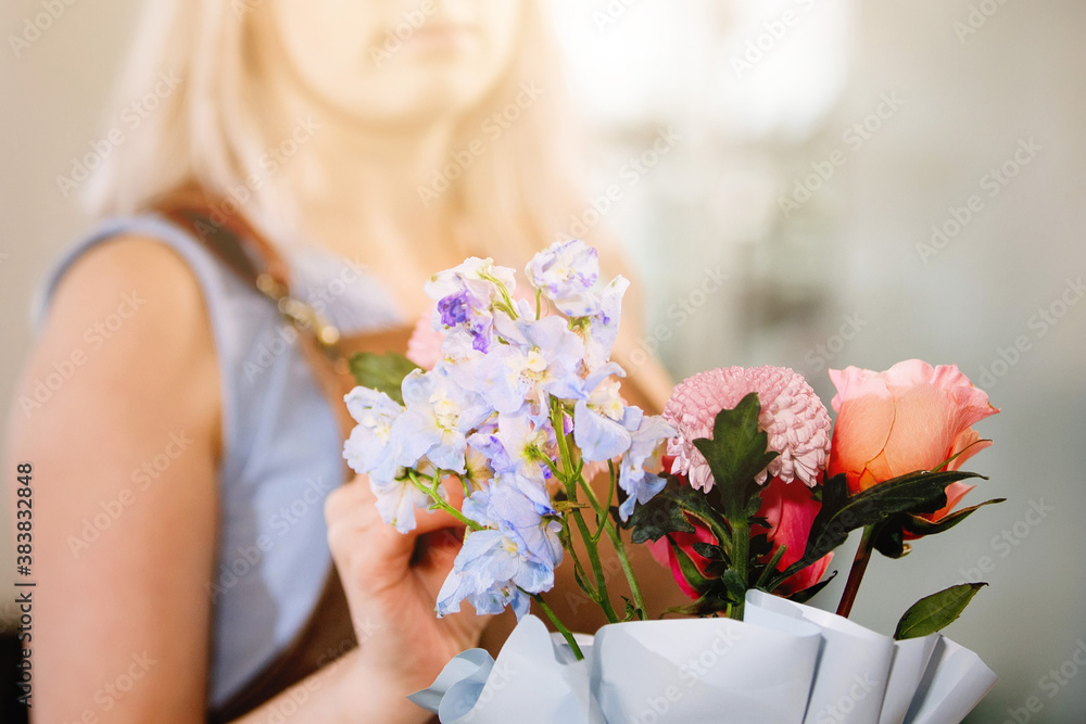 Woman florist collects a bouquet Woman florist collects a bouquet