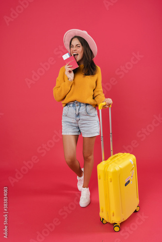 Happy young female walking with the travel bag