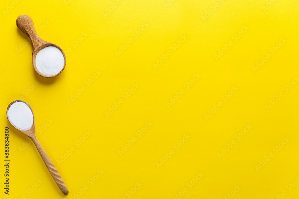 Marine collagen powder in wooden spoons on a yellow background. Dietary supplement. Horizontal orientation, top view, copy space. Marine collagen powder in wooden spoons on a yellow background. Dietary supplement. Horizontal orientation, top view, copy space.