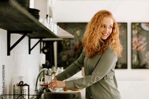Smiling woman in office kitchen
