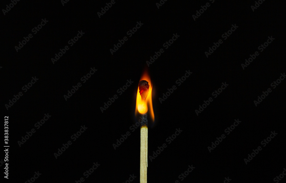 close up Single matchstick burning isolated on black background. close up Single matchstick burning isolated on black background.