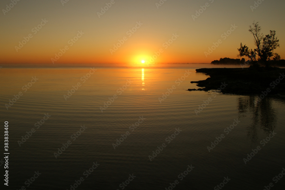 dawn on a tropical island. dawn in the tropics. calm water in which the rising sun is reflected