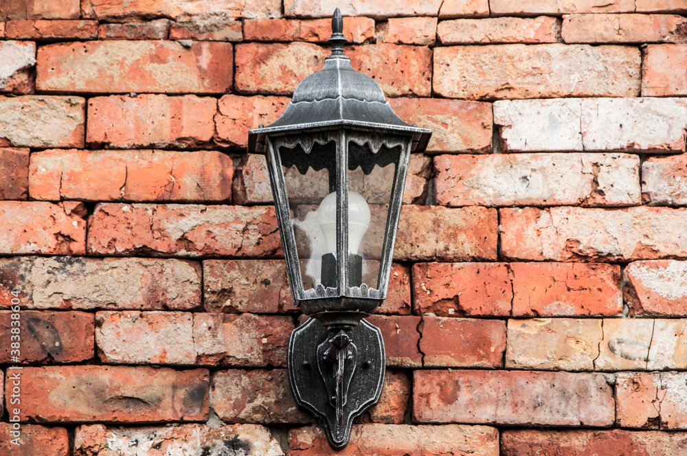  lantern on a brick background. old lamp on the wall. lamp on decorative surface