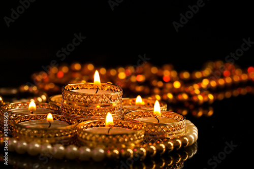 Indian festival diwali , candle on dark background