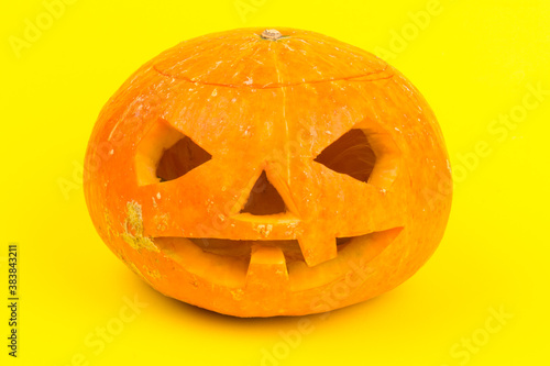Glowing Halloween Pumpkin isolated on yellow background