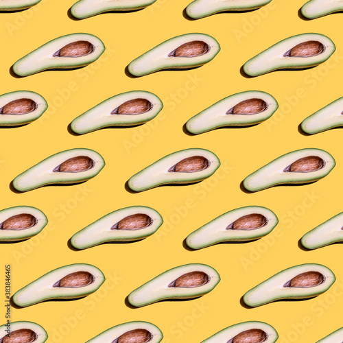 Seamless pattern with avocado on yellow background.