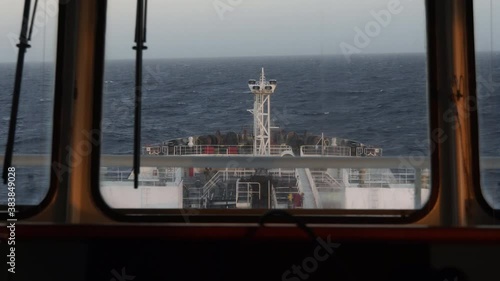 Impact of a wave on the bow of an oil tanker, view through the window from the navigating bridge.