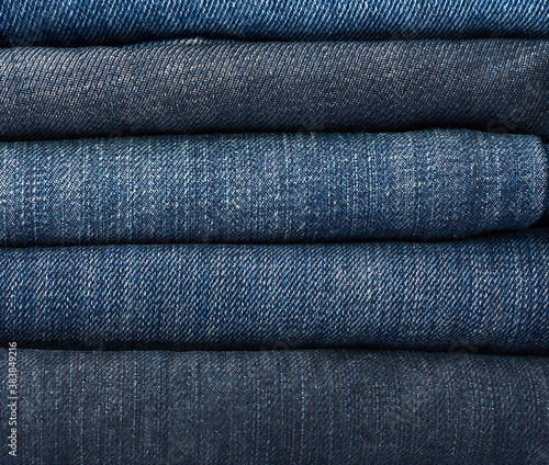 stack of folded blue jeans pants, full frame