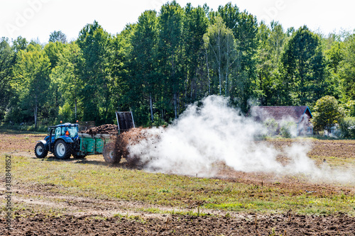 Tractor fertilizing field photo