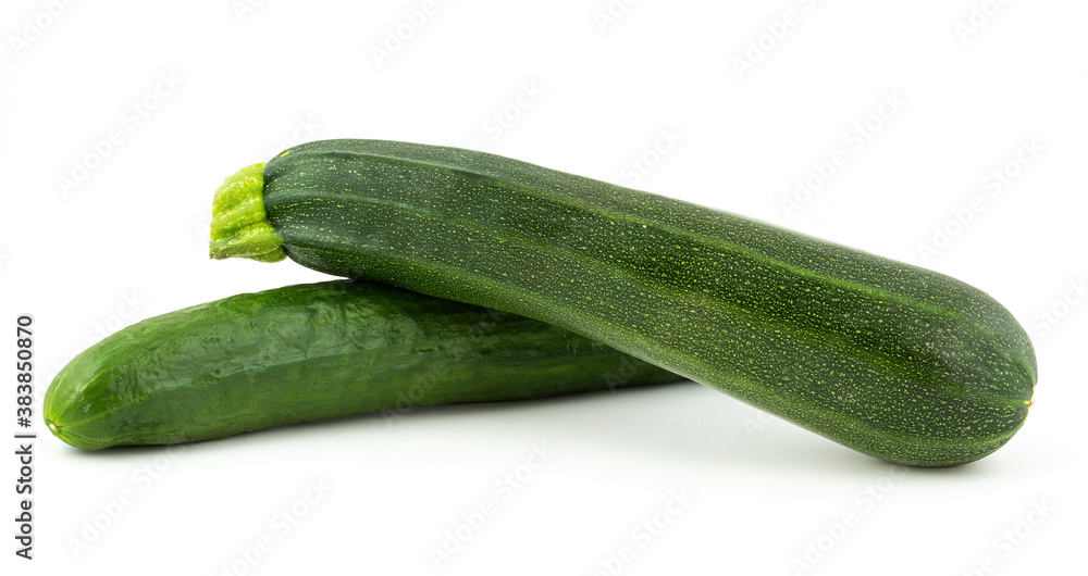 Green cucumber and green zucchini isolated on a white background. Green cucumber and green zucchini isolated on a white background.