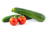 Green cucumber, green zucchini and two red tomatos isolated on a white background.