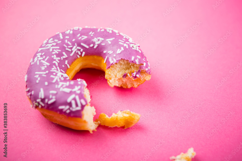 Studio shot of a colorful donut on pink background. Studio shot of a colorful donut on pink background.