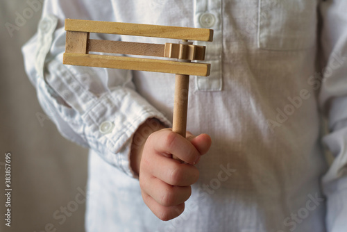 Traditional toy noisemaker in the hand of a child for Jewish holiday Purim. photo