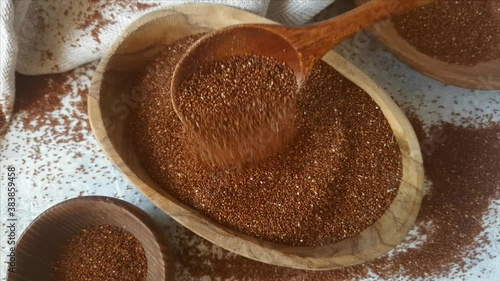 Raw teff grain in a wooden bowl close up