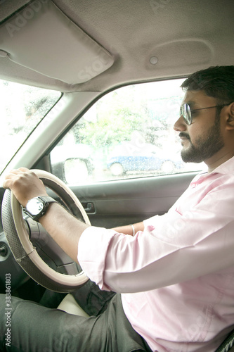 an Indian man driving a car