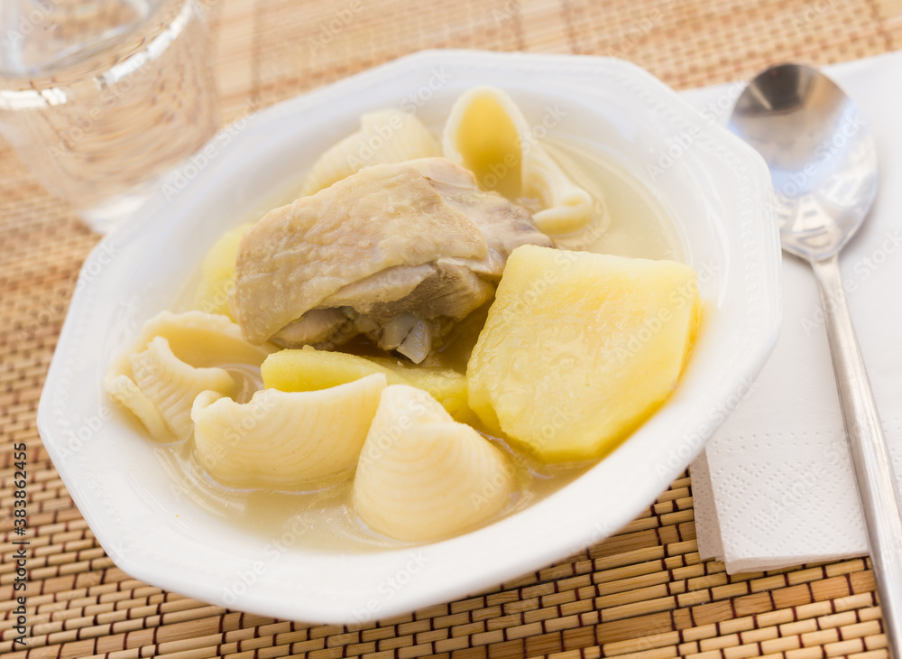 chicken broth soup with chicken, potatoes, and pasta shells chicken broth soup with chicken, potatoes, and pasta shells