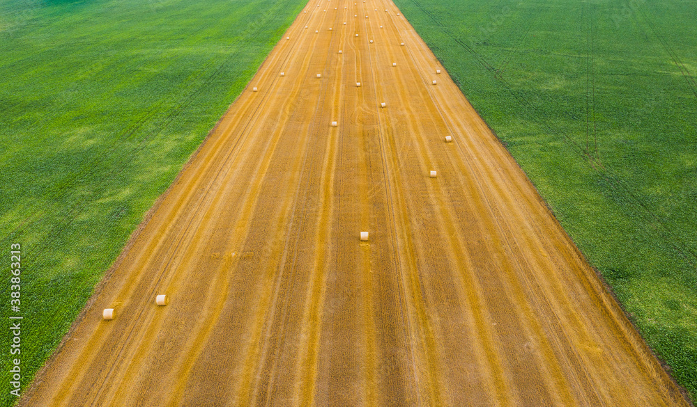 Obraz premium Aerial view of hay bale stacks at countryside