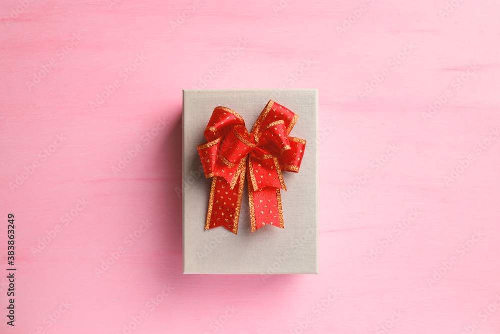 Gift box with red ribbon on pink background, present for giving in special day, Top view Gift box with red ribbon on pink background, present for giving in special day, Top view