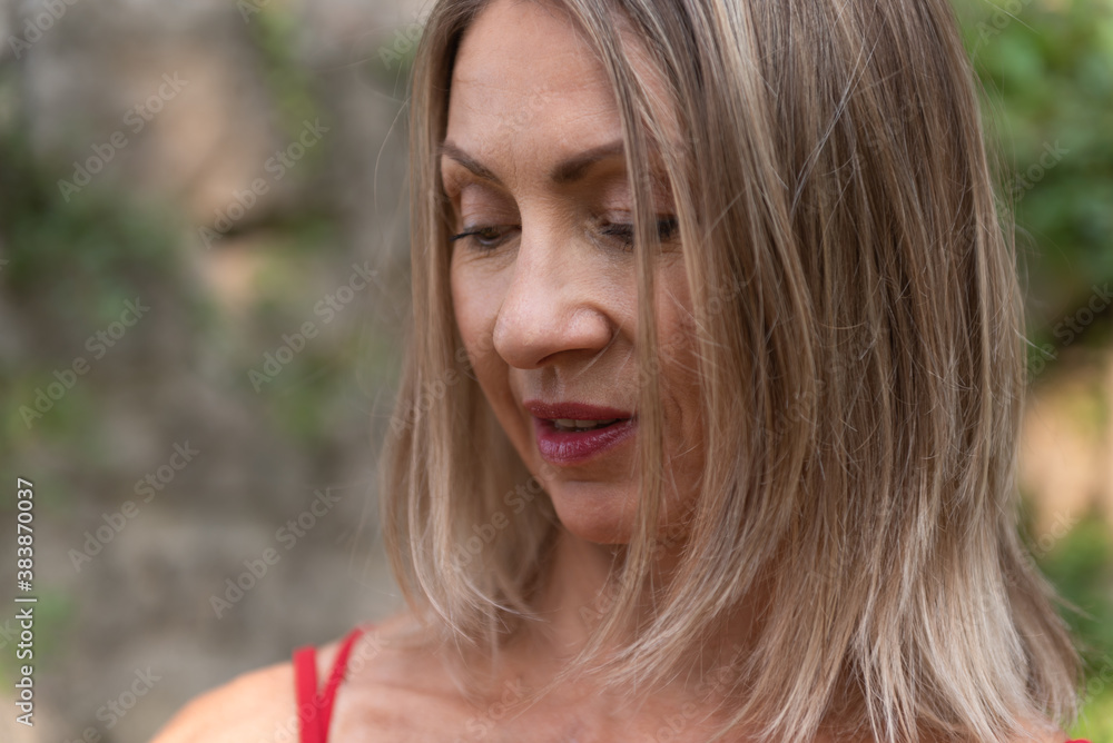 Close up happy adult woman with long blond hair Close up happy adult woman with long blond hair
