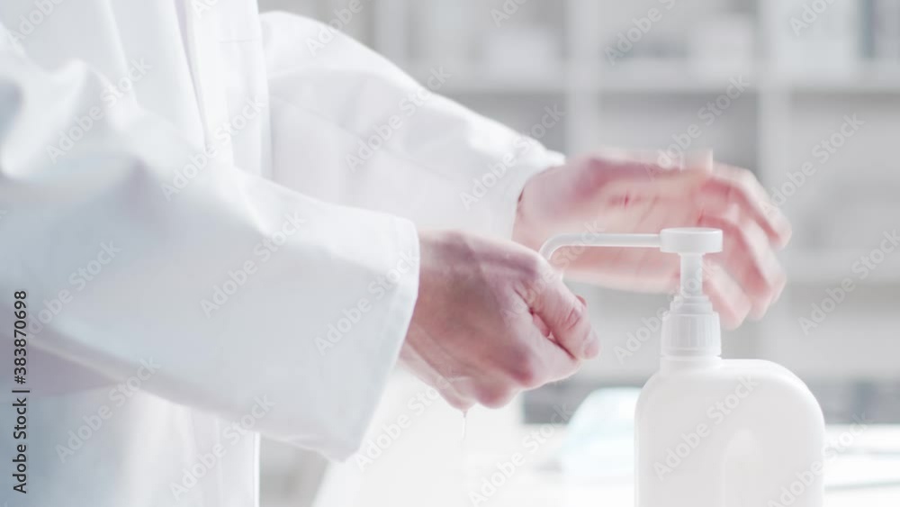 Close-up of doctor cleaning hands using disinfectant with medical soap. Office in hospital on the background. Close-up of doctor cleaning hands using disinfectant with medical soap. Office in hospital on the background.