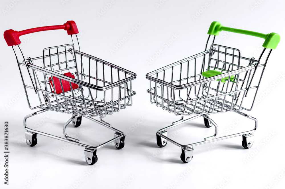 green and red empty carts on a light background close up trade green and red empty carts on a light background close up trade
