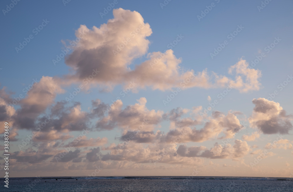 Cumulus Clouds above South Pacific Ocean at Sunset