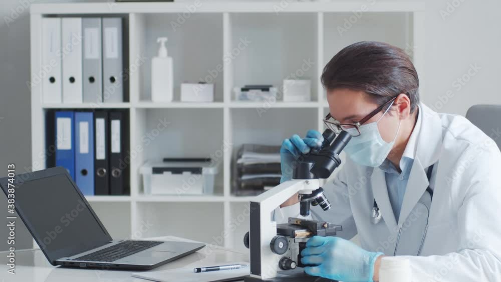 Professional medical doctor working in laboratory using microscope. Professional medical doctor working in laboratory using microscope.