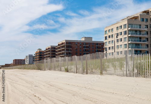 Row of Buildings and Fence along the Boardwalk in Long Beach New York during Summer