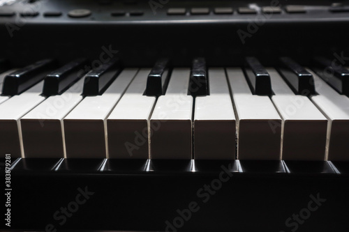 piano keys in bright light and dark shadow